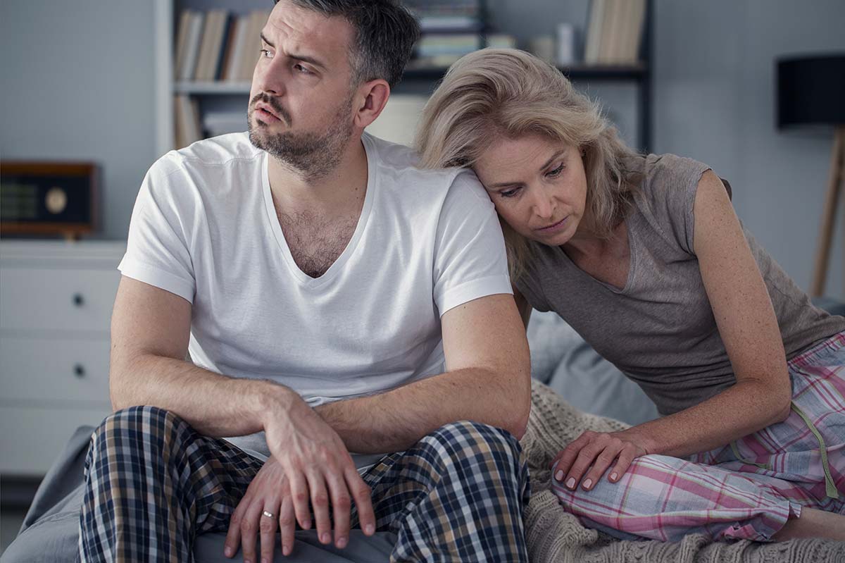 Illustration of a married couple sitting together with sad expressions, contemplating the possibility of ending a relationship due to emotional distress and difficulties.