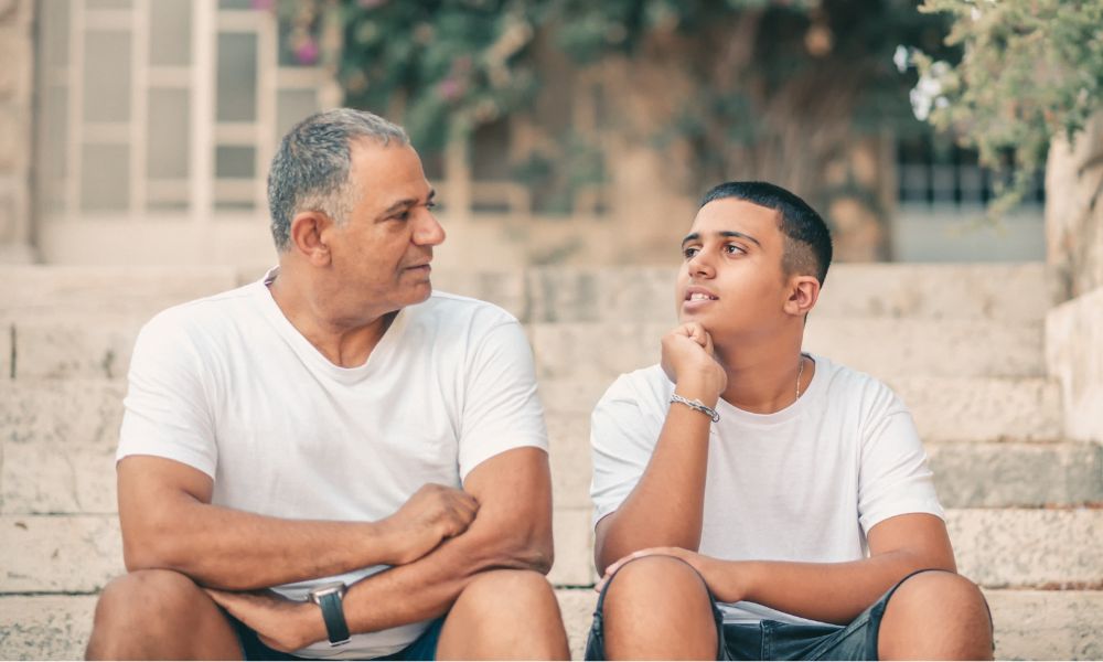 After coaching for single dads, a father and son in matching white t-shirts can communicate better