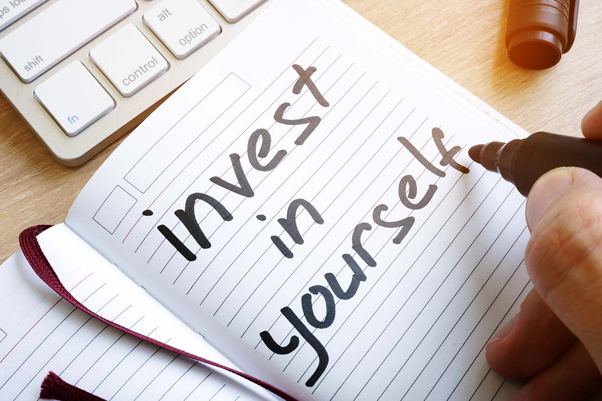 A journal with the words "Invest in Yourself